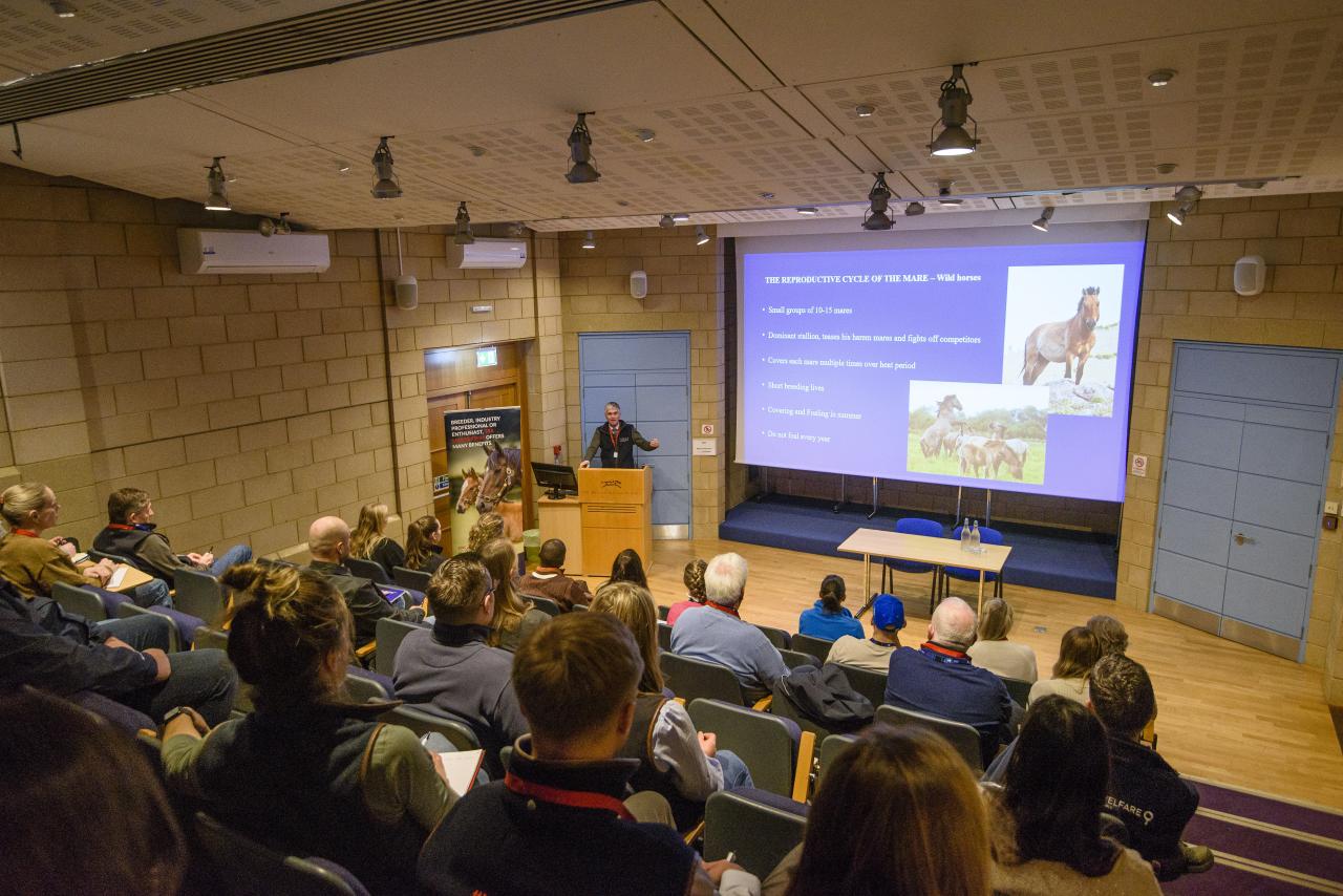 Delegates in a lecture theatre listen to a speaker.