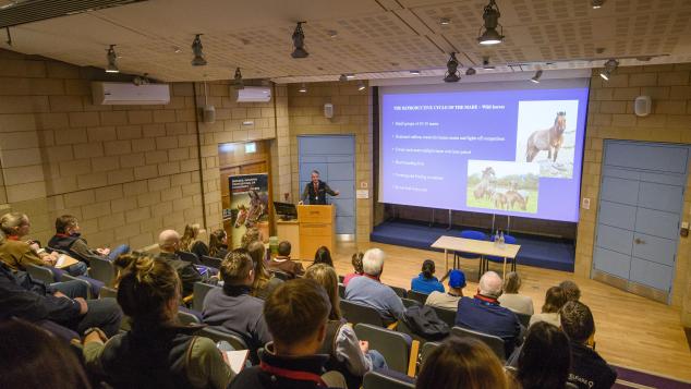 Delegates in a lecture theatre listen to a speaker.